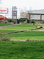 The ruins with Abbey Retail Park and Canary Wharf in the background