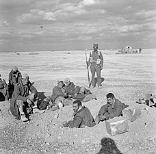 Indian soldiers guard Italian prisoners near El Adem Aerodrome
