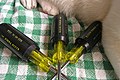 Three Klein screwdrivers, with their distinctive handles.