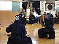 Kendōka perform sonkyo after combat.