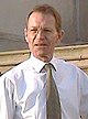 Nicholas Serota, a man wearing a white shirt and a solidly colored tie