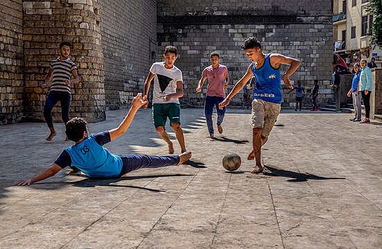 Boys playing street football in Cairo, Egypt