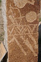 Detail of deer stone, with weapons