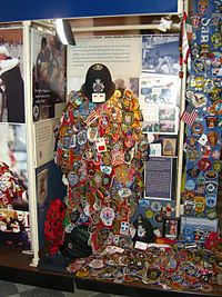"Healing Hearts and Minds", an exhibit inside the chapel, consisting of a red chasuble covered with police and firefighter patches sent from all over the world. A British Bobby's helmet is on top