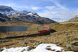 Regional train on the Bernina line on the shores of Lake Nero in the Lago Bianco to the Bernina Pass