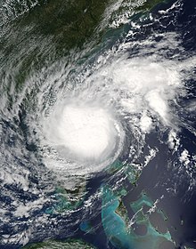 A satellite image of a tropical cyclone featuring a round, dense area of clouds.