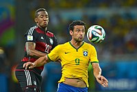 Brazil's forward Fred is challenged by Germany's defender Jérôme Boateng