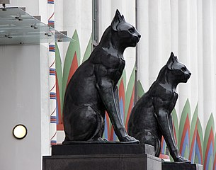 The pair of black cats, modelled on Bastet, guarding the factory entrance