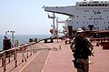 A member of USCG Law Enforcement Detachment (LEDET) 106 performing a security sweep aboard a tanker ship in the North Persian Gulf in July 2007