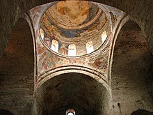 Photograph of a church dome covered with frescoes. From inside the building.