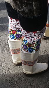 Ceremonial kamik boots worn by women in Greenland during special occasions. Shorter sealskin outer boots are worn over decorated textile thigh-high inners. Sisimiut, Greenland