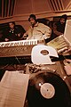 Image 3Hip hop producer and rapper RZA in a music studio with two collaborators. Pictured in the foreground is a synthesizer keyboard and a number of vinyl records; both of these items are key tools that producers and DJs use to create hip hop beats. (from Hip hop production)