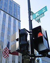 Street sign for K Street, with tall office buildings in background