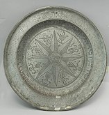 A plate made of pewter, an alloy of 85–99% tin and (usually) copper. Pewter was first used around the beginning of the Bronze Age in the Near East.