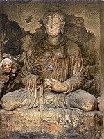 Seated Buddha with "Vajrapani-Alexander" attendant. Tapa Shotor (Niche V3).[24]
