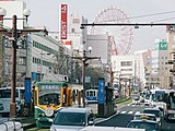 Kajiyachō Tram Stop with its back to the Kagoshima-Chūō Station Building having ferris wheel