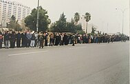 Crowds of people waiting for royal motorcade carrying King Hussein's coffin
