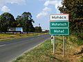 Multilingual (Hungarian, German and Croatian) city limit sign