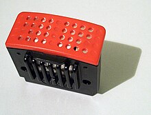 A rectangular cartridge consisting of a black base and a flat, red top