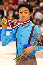 A photograph of Nathan Chen holding his gold medal at the medal ceremony following the 2014 U.S. championships.