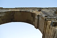 The underside of an arch on the second tier of the Pont du Gard. Note the missing stonework atop the aqueduct.