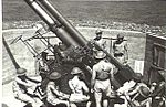 Gunners working on 3.7-inch (94 mm) heavy anti-aircraft gun. 1943. [gallery 21]