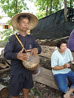 Medium Klong yao hand-drum, player in Laos