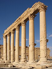 These are composed of stacked segments and finished in the Corinthian style, at the Temple of Bel (Syria)