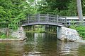 The arched Lily Pond Foot Bridge crosses its inlet on Brantingham Lake, New York