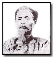 Khả in traditional Mandarin robes.