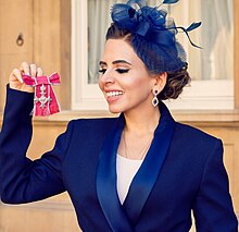 Dasani with the MBE Medal at Buckingham Palace