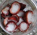 Fresh Kokum fruit filled with sugar in glass jar and kept under the sun to make kokum syrup for refreshments.