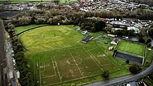 A picture depicting an aerial view of the local recreation grounds. It mainly focuses on the green, grass field. There are rugby and football markings on a suitably sized pitch.