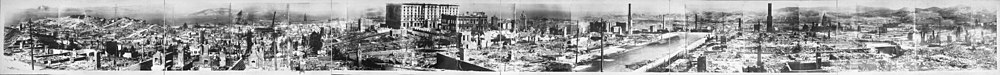 A 160-degree panoramic view of damage across the city after the disaster in 1906. In the distance, some large buildings remain, but most smaller structures are reduced to piles of rubble, with some chimney stacks remaining.
