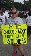A woman protesting against the militarization of police