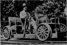 A man sitting on a small rail vehicle.