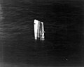 The bow of USS Fiske floating in the North Atlantic after she was broken in two by a torpedo from the German submarine U-804 on 2 August 1944. This section had to be sunk by gunfire. Photographed from an airplane based on USS Wake Island; note the sonar dome on Fiske's keel.