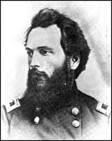Black and white photo of a bearded man in a dark military uniform with general's stars on the shoulder tabs