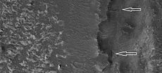 Dark-toned layers shown with white arrows, as seen by HiRISE. This is in same region as previous two images.