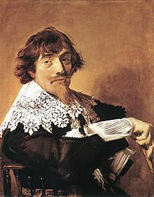 Man seated sideways on a chair, facing viewer, whose garment has an intricately patterned lace collar.