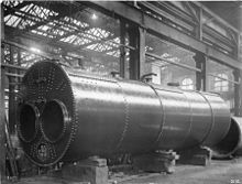 Lancashire boiler 1900, painted with a protective coating, the mountings such as safety valves, stop valve, feed check valves and water level gauges, have been removed.[112]