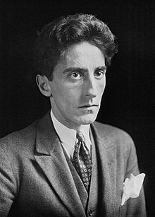 Black and white photo of Jean Cocteau in a suit