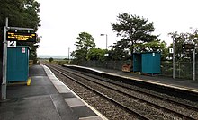 Llangennech railway station with passenger shelters and electronic displays.