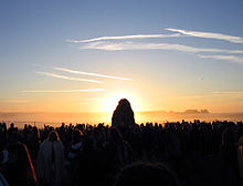 The sun is directly behind the Heel Stone of Stonehenge, at sunrise on the summer solstice
