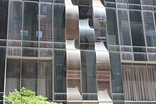 A portion of the lower-story facade of One57 with wavy vertical strips