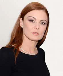 Elena Podzámska wearing a black top, gazing directly at camera with parted lips