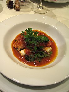 Plated dish of lobster with sauce américaine