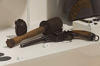 M17 grenade among a British Mills bomb grenade and a M1879 Reichsrevolver