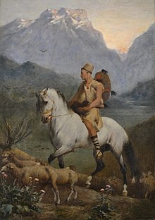Man on horseback herding goats