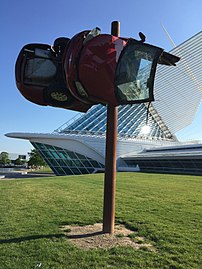 A wrecked car installed on a pole near the museum, taken off view in spring of 2017